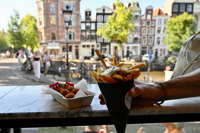 10 Tastes of Amsterdam: Food Tour by UNESCO Canals and Jordaan - Fresh stroopwafels at a 200-year-old bakery