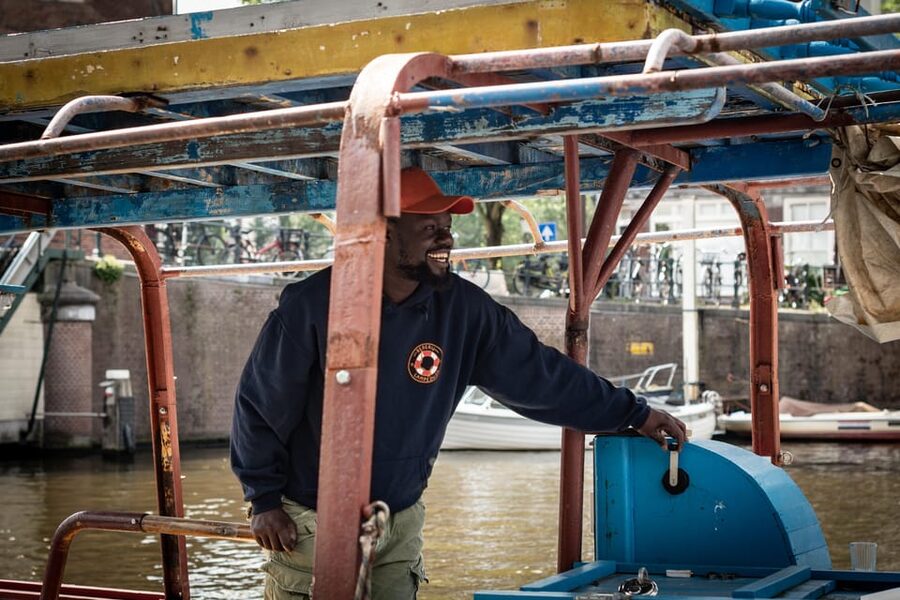 Amsterdam: Canal Cruise on a Wooden Refugee Boat - Personal stories from guides who came to Amsterdam as refugees