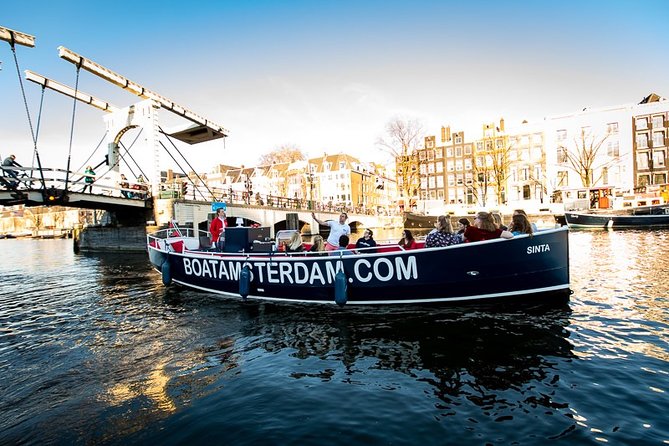 Amsterdam Canal Cruise With Live Guide and Unlimited Drinks - Museums, towers, and the eastern canals