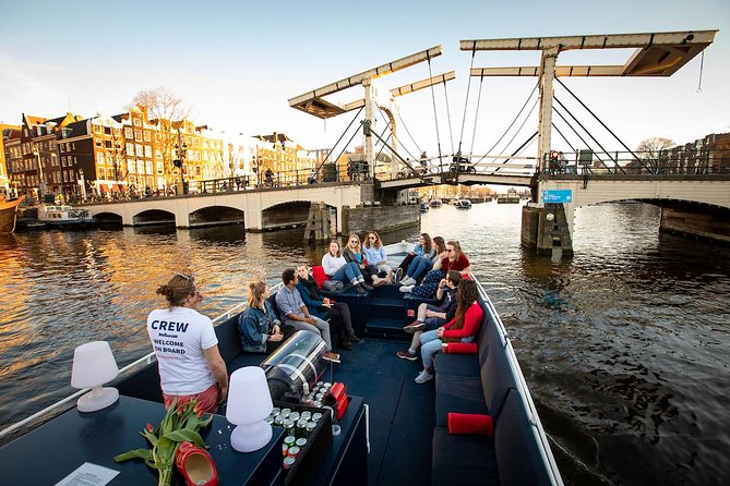 Amsterdam Canal Cruise With Live Guide and Unlimited Drinks - Open-air views, rain, and winter comfort