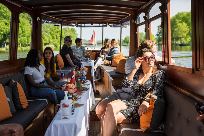 Amsterdam Classic Saloon Boat Cruise with Drinks and Cheese - Skinny Bridge, Munttoren, and Bloemenmarkt