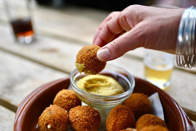 Amsterdam Food Tour of 10+ Local Classic Tastings in Jordaan Area - The fishmonger stop: herring and kibbeling