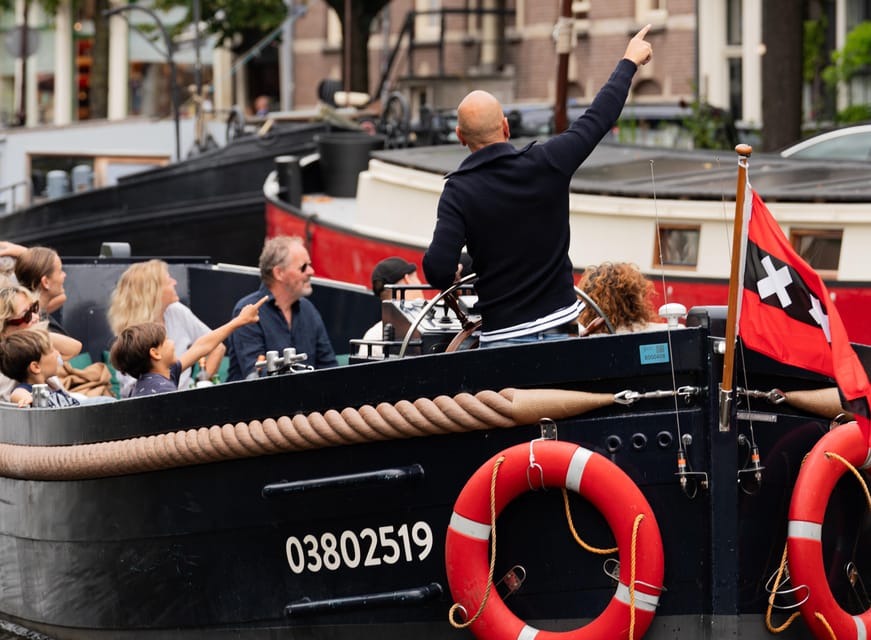 Amsterdam: Guided Open Boat Canal Cruise Including Drink - Weather, comfort, and the one-hour limit