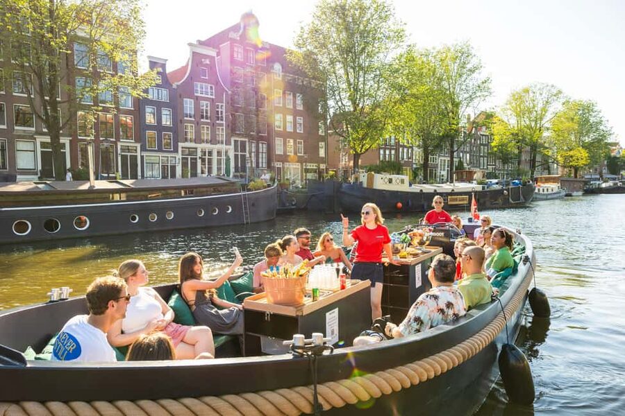 Amsterdam: Guided Open Boat Canal Cruise Including Drink - From the station to the old harbor sights