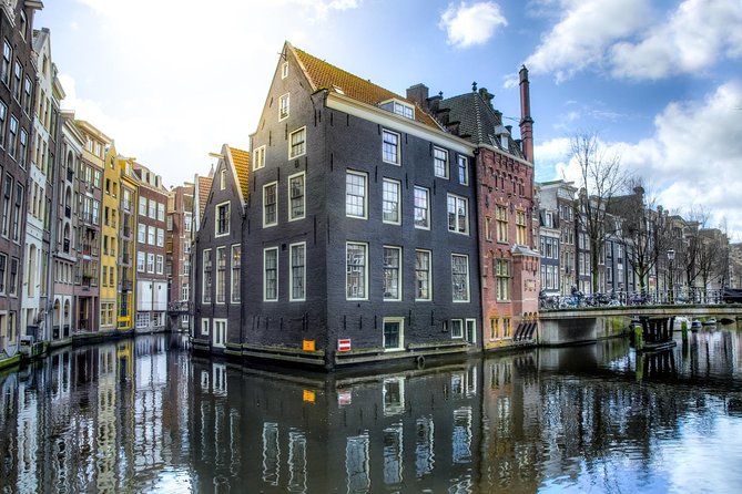 Amsterdam Layover: Walking Tour & Canal Cruise + Airport Transfer - Booking, timing, and cancellation details