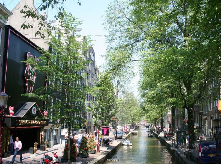Amsterdam: Red Light District and Coffeeshop tour - Starting among canals and old Amsterdam buildings