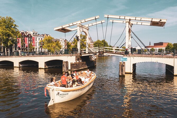 Amsterdam: Saloon Boat Cruise + Unlimited Drinks & Bite option - Zuiderkerk tower and the city skyline
