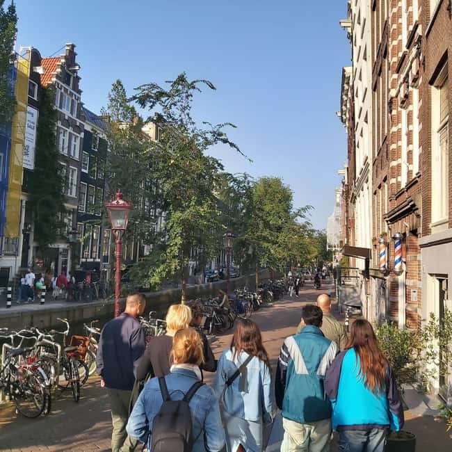 Amsterdam: Spanish Tour Unmasking the Redlight District - Finishing near Beursplein and Dam Square