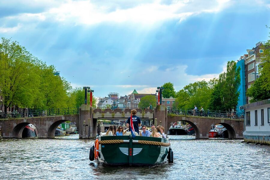 Amsterdam: The Newest Canal Cruise with Drink Option - The opening stretch: Central Station, St. Nicholas, and the old harbor