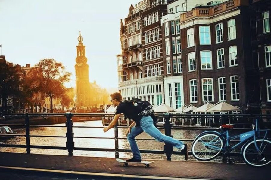 Amsterdam: The Story of History & Culture Walking Tour - Canals, historic buildings, and photo stops
