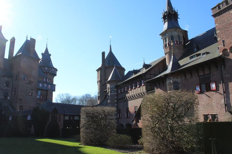 From Amsterdam: Castle De Haar Guided Tour - Crossing the grounds at Castle De Haar